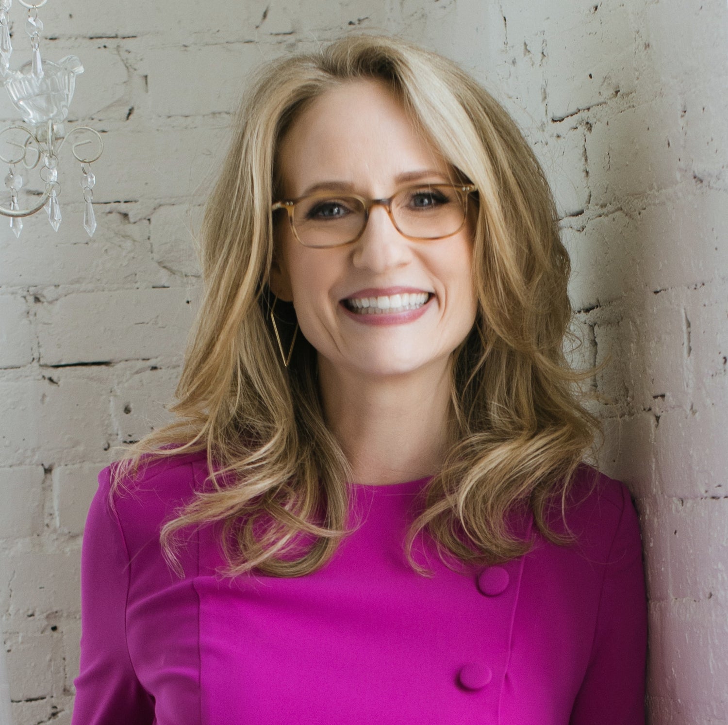 Dr. Nicole Beurkens headshot - blonde women with glasses and magenta pink sweater