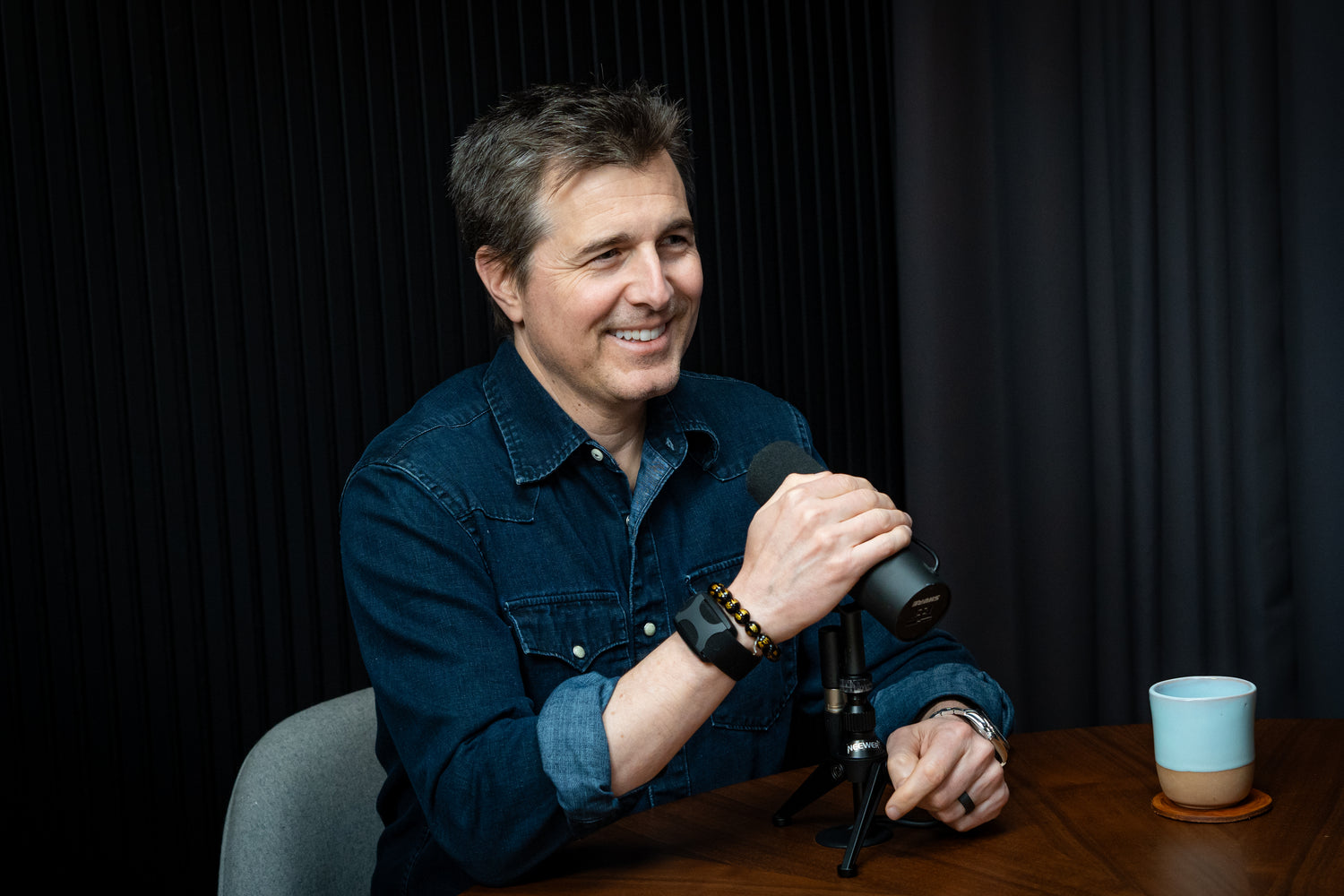 Dr Michael Gervais wearing an Apollo wearable with a microphone in his right hand