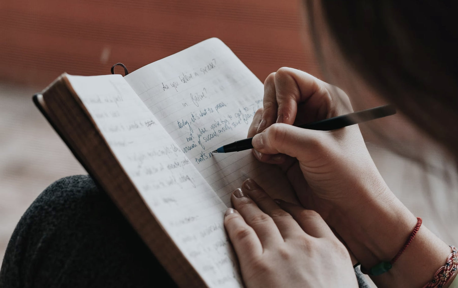 Woman writing in gratitude journal