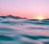 Photo of waves in the sunrise with the sun coming over the horizon