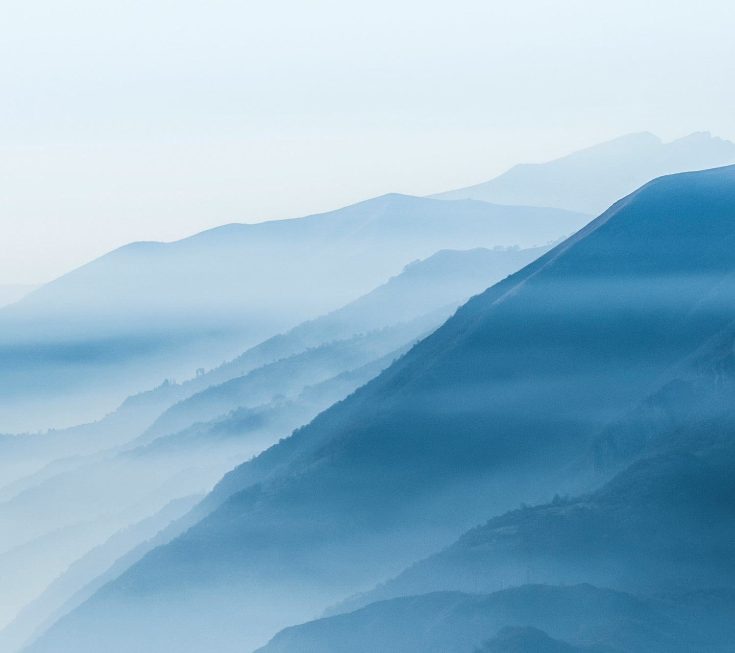 Cloud covered mountains with a blue filter