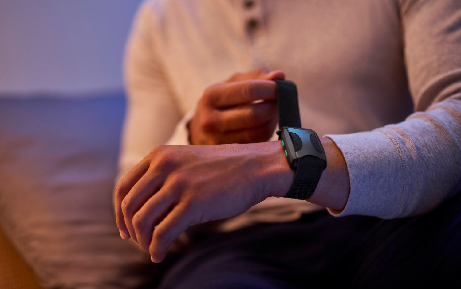 Man putting Apollo on wrist in at night