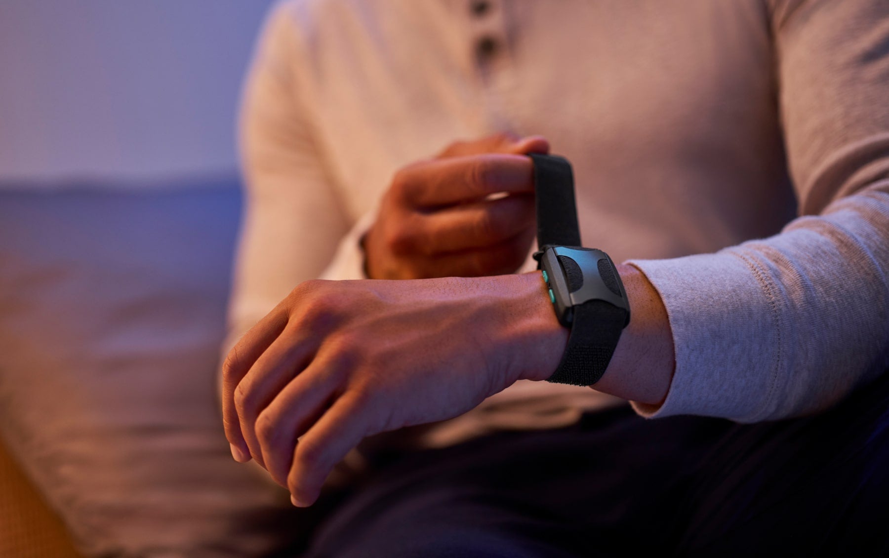 Man putting Apollo on wrist in at night