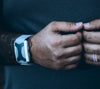 Man's hands coming together with an Apollo wearable on his wrist