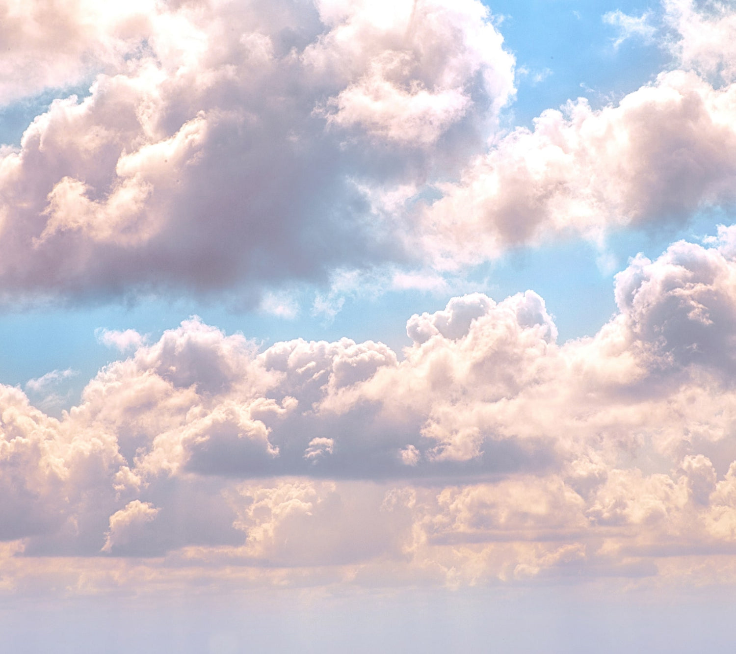 Light blue sky with big white billowy clouds