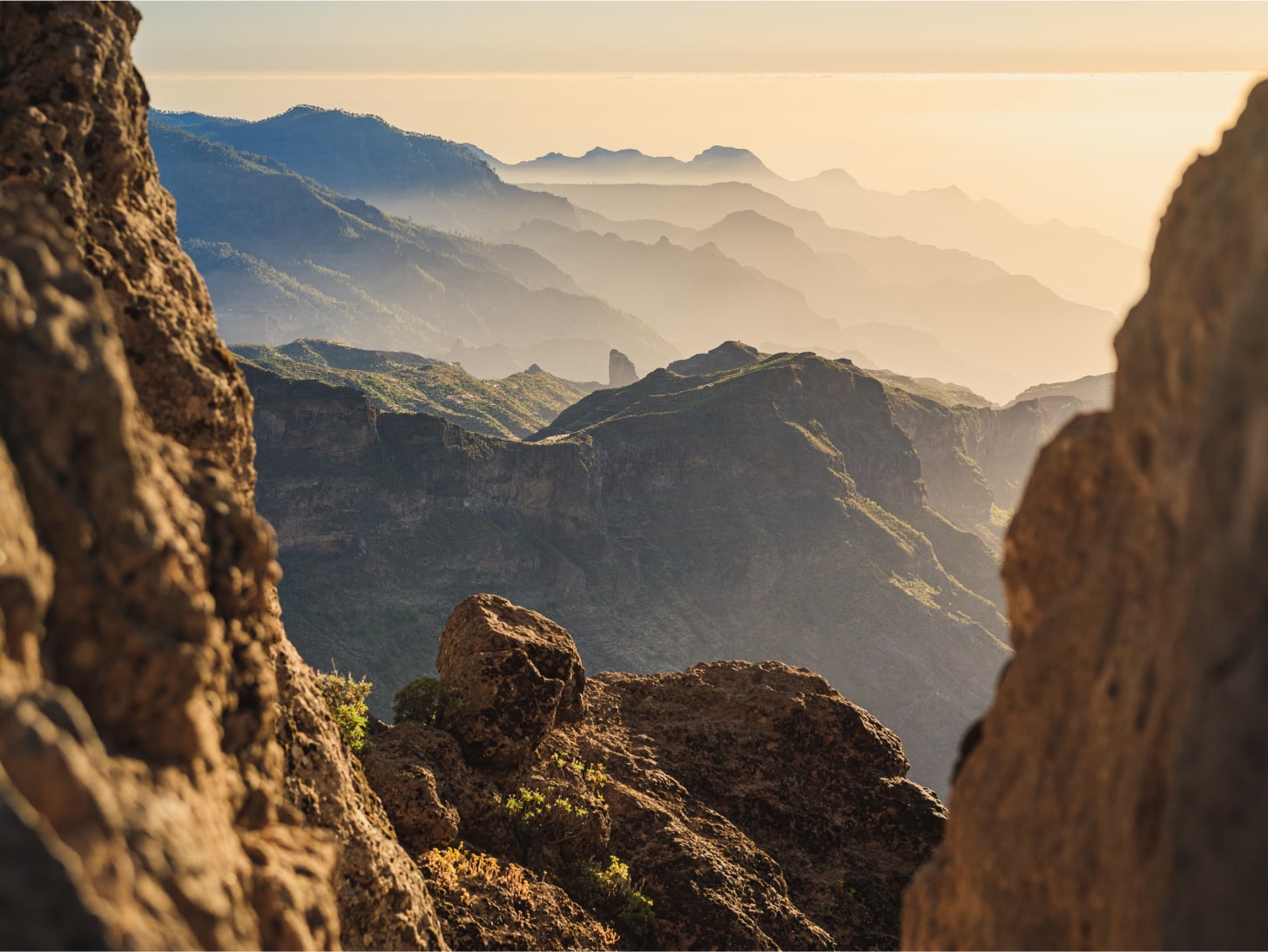 Image of fog covered peaks taken from high altitude between two cliffs