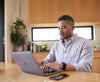 A man working at his computer with a Stealth Apollo on his wrist